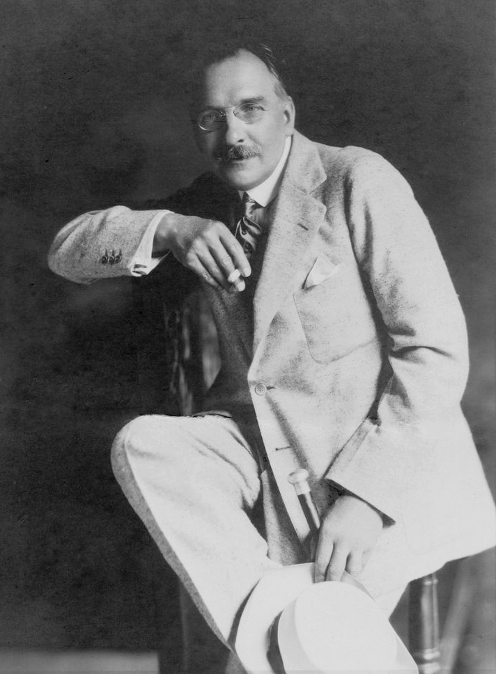 Wilfrid Voynich, a bearded man in a pale suit, seated, photographed around 1923